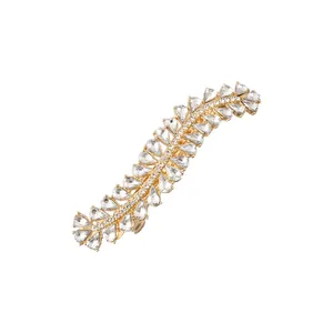 Close-up of golden alloy hair clip featuring multi-shaped clear sparkling rhinestones