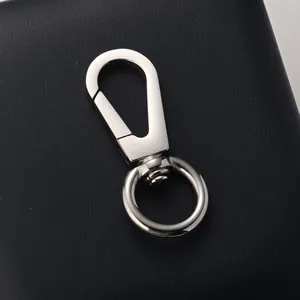 Polished silver titanium steel swivel lobster clasp on a black leather background