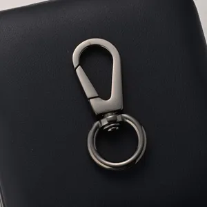 Premium gunmetal swivel lobster clasp with spring hook on dark blue leather texture