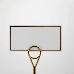 Elegant gold metal table card holder with a minimalist white border place card