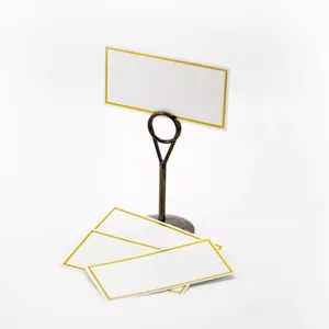Elegant gold-bordered table cards with stable metallic card holder for wedding seating