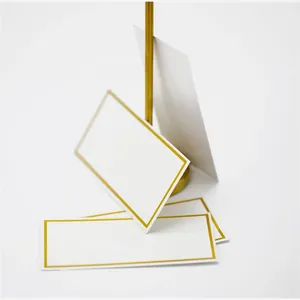 Elegant white wedding place cards with gold foil borders and matching metal stand set