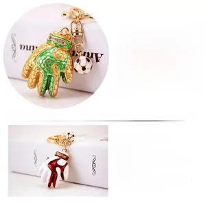 Detail showing the size and weight of football glove metal keychain with rhinestones