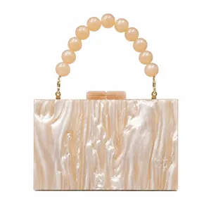 Elegant pearlescent acrylic evening clutch bag with round pearl beaded handle