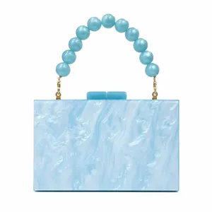 Front view of light blue marble acrylic evening bag with beaded handle and gold hardware