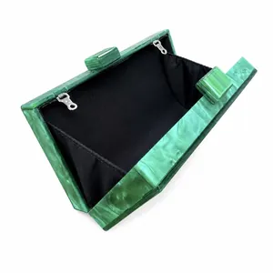 Detail view of green marble acrylic evening bag with black lining and metal hooks