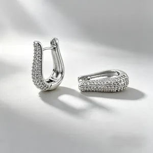 Elegant silver U-shaped hoop earrings with sparkling cubic zirconia on light grey background
