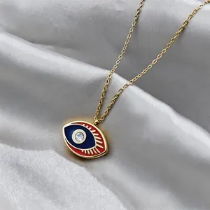 Detail of evil eye pendant with blue enamel, red eyelashes, and a center zircon stone