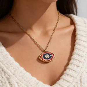 Detailed close-up of a vintage evil eye necklace featuring blue enamel and gold finish