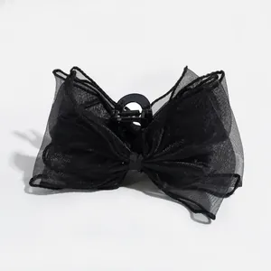 Elegant black oversized mesh bow hair claw clip with a glossy finish for women