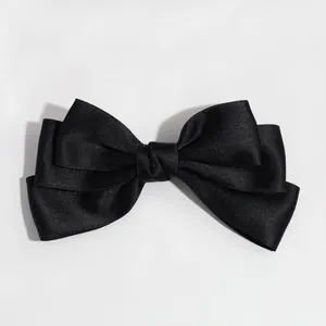 Elegant black satin bow hair clip with a smooth glossy finish for hair accessories