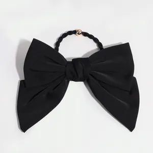 Classic black satin bow hair clip with golden bead detail for elegant hairstyles