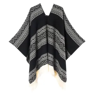 Detail of western style poncho showing grey geometric weaving and white fringe trim