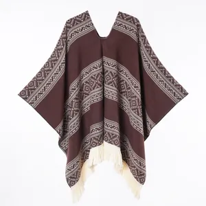 Detail of western style knit poncho with geometric patterns and white fringe trim