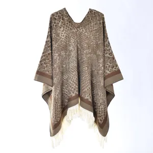 Close-up of leopard pattern knit poncho with tassel details and V-neckline