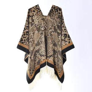 Close-up of leopard and snake print poncho with tassel hem and knit texture details