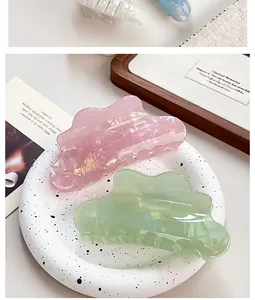 Detail view of pearlescent marble cloud hair claw clip on decorative tray