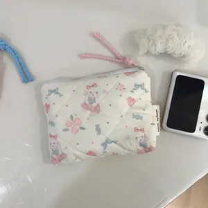 Detailed macro of a quilted cotton coin purse with cute bunny and floral prints