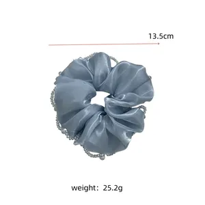Detail of light blue satin scrunchie with beaded edges, 13.5cm diameter and 25.2g weight