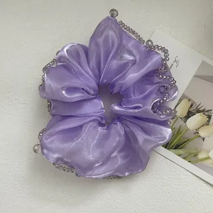 Detail of lavender satin hair scrunchie featuring elegant beaded crystal edges