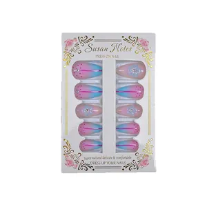 Short almond press-on nails with pink and blue gradient, rhinestones, and floral art