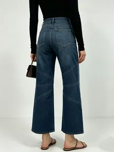 Detail view of contrast stitching and curved seam design on high waist denim pants