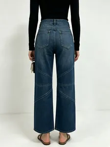 Detailed back view of high-waisted wide leg jeans with diagonal stitching and washed denim