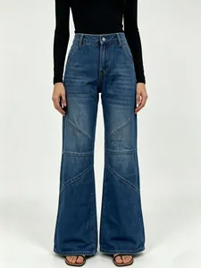 Detail showing the diagonal patchwork stitching and vintage wash on wide-leg denim jeans