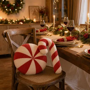Close-up of peppermint and candy cane plush pillows on a festive Christmas dinner table