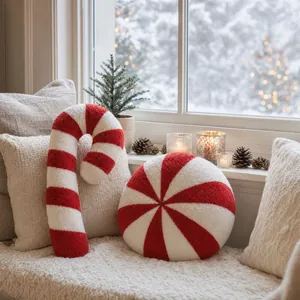 Detail of candy cane and peppermint plush pillows in a cozy snowy window scene
