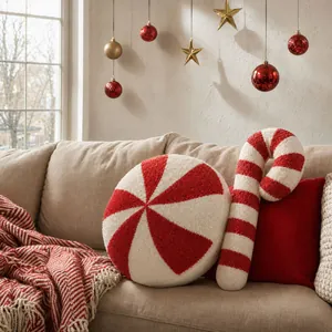Detail of plush round candy and candy cane pillows with festive Christmas holiday decor