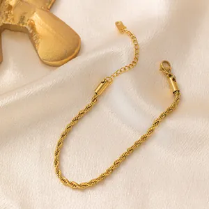 Detailed close-up of golden rope chain bracelet with lobster clasp and adjustable link