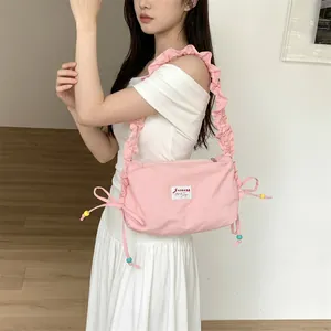 Close-up of pink ruched canvas bag with colorful drawstrings and ruffles detail