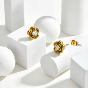 Detail of camellia flower earrings with gold plating and sparkling zircon centers