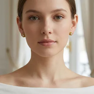 Elegant gold camellia stud earrings with center zircon on female model for jewelry styling