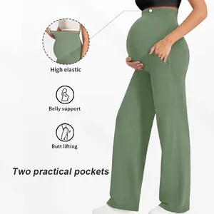 Détail de la taille élastique et de la bande de soutien sur le pantalon de grossesse vert