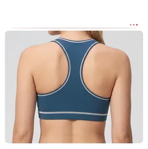 Macro detail of the racerback design and contrasting white piping on navy blue sports bra