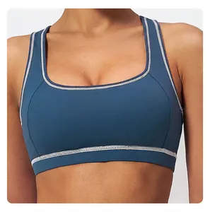 Detail of the wide hem and white contrast stitching on this navy blue sports bra
