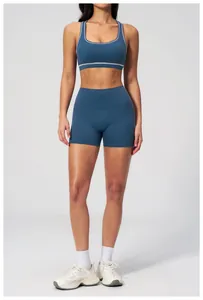 Detail of high-stretch navy blue yoga sports bra and shorts set with white trim accents