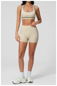 Detail of contrast binding on beige racerback sports bra and high-waist yoga shorts set