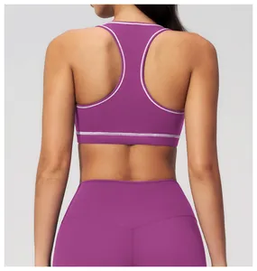 Detail of purple racerback sports bra with white contrast stitching and high waist fit
