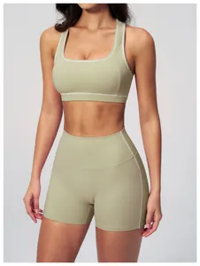 Close-up of contrast stitching detail on sage green racerback yoga sports bra