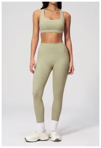 Detail of high-waist yoga leggings and square neck sports bra in light olive green