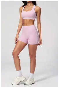 Detail of light pink racerback sports bra and shorts with white contrast piping
