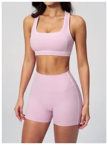 Detail of pink yoga set showing white contrast trim on bra and high waist shorts