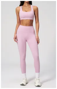Close-up of pink yoga bra with white piping and high-waist stretch leggings