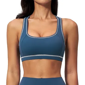 Women's navy blue racerback yoga sports bra with contrast stitching and U-neck