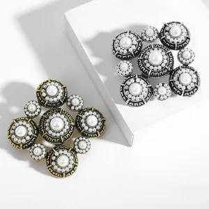 Baroque pearl brooch in gold and silver finish with vintage textured metal frame