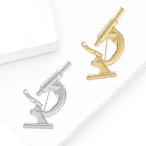 Minimalist gold and silver microscope lapel pins in polished alloy for science lovers