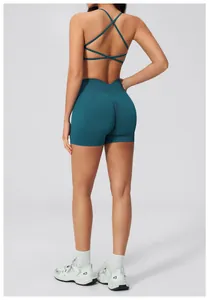 Detail view of teal seamless cross-back sports bra and high waist scrunch butt gym shorts